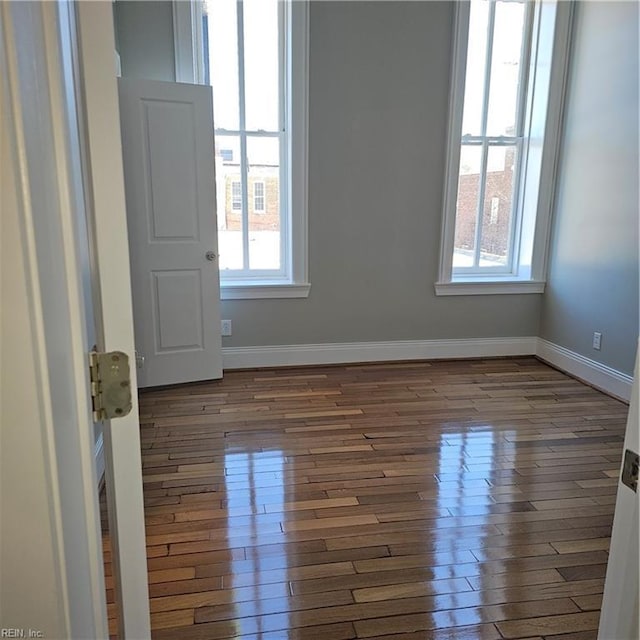 unfurnished room featuring dark hardwood / wood-style flooring