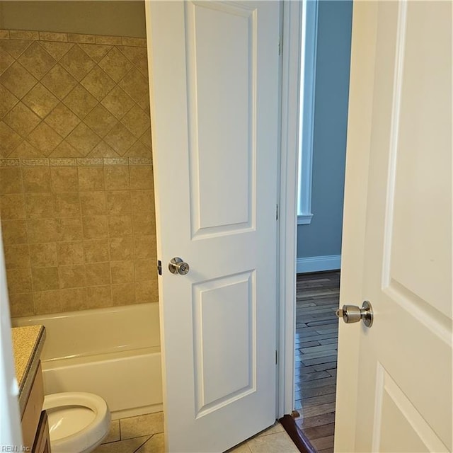 bathroom with vanity, toilet, and tile patterned flooring