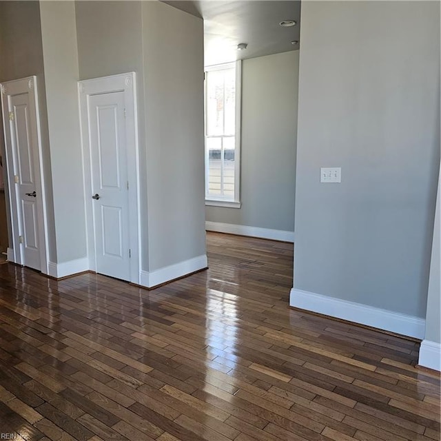 empty room featuring dark hardwood / wood-style flooring