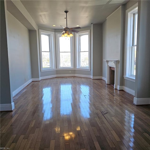 unfurnished dining area featuring dark hardwood / wood-style flooring and a healthy amount of sunlight