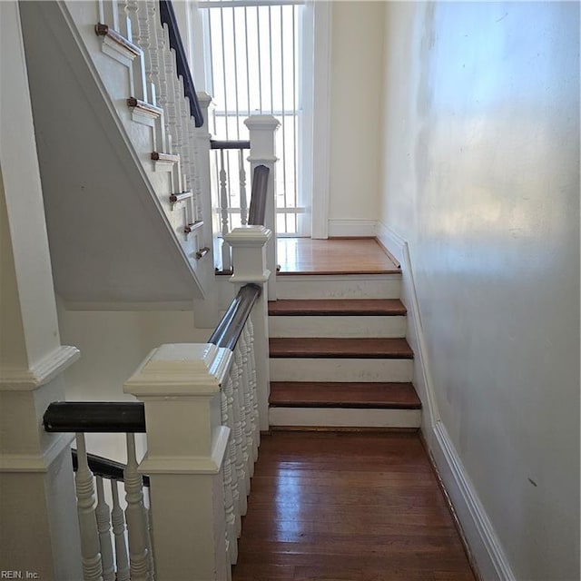 staircase featuring wood-type flooring