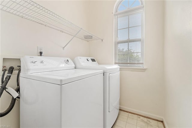 laundry room featuring light tile patterned floors and washing machine and dryer