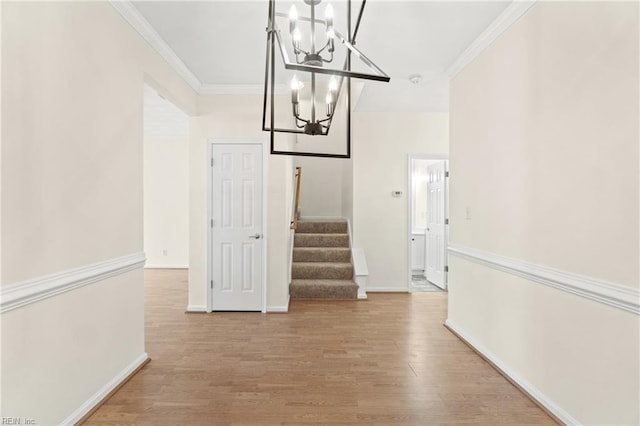 interior space with hardwood / wood-style floors, ornamental molding, and a chandelier