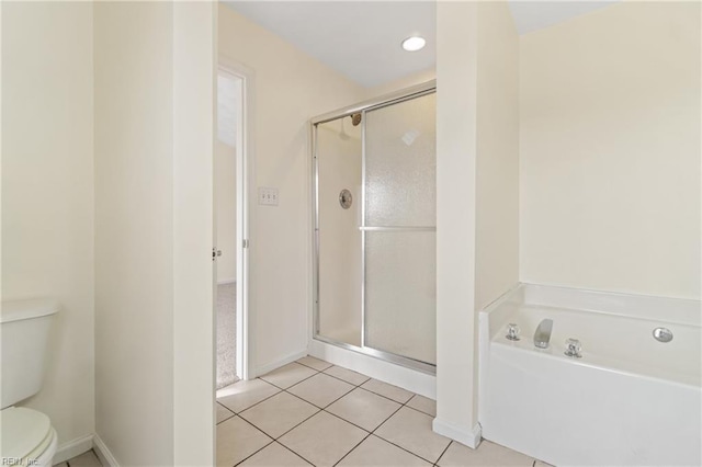 bathroom featuring toilet, independent shower and bath, and tile patterned flooring