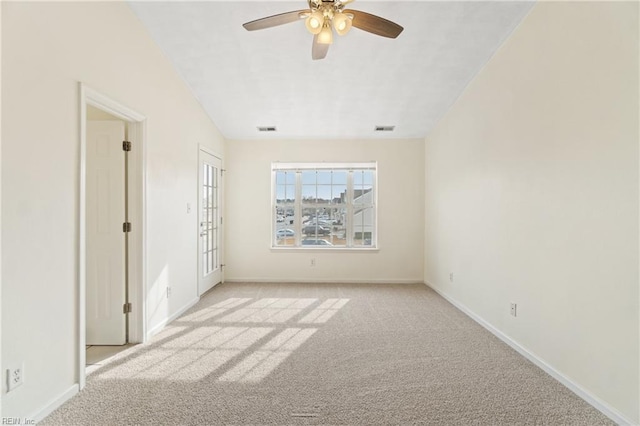 unfurnished room with light colored carpet and ceiling fan