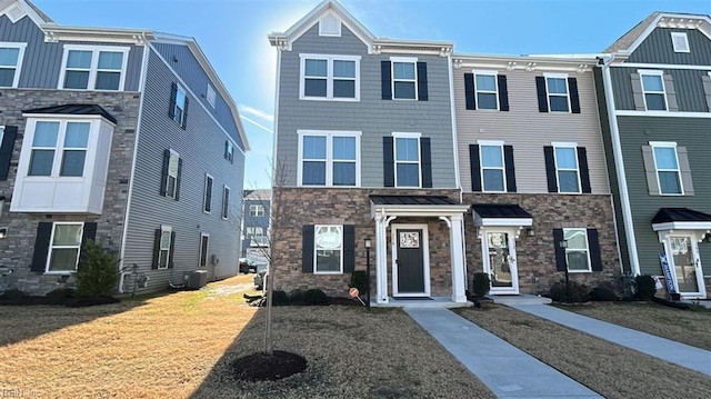 multi unit property featuring central AC unit and a front lawn