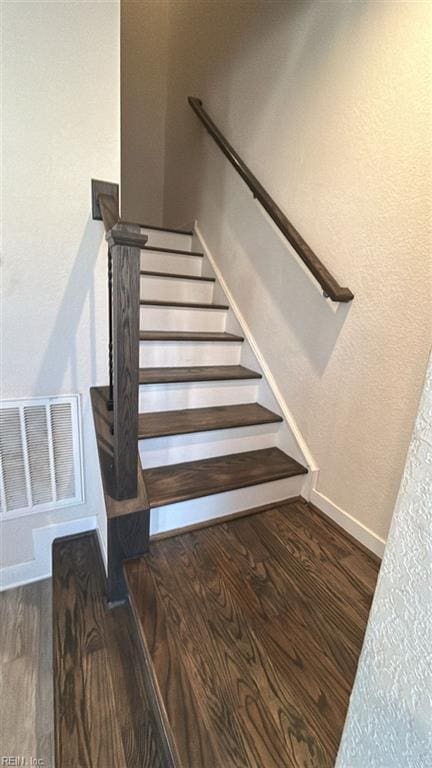 stairway with hardwood / wood-style floors