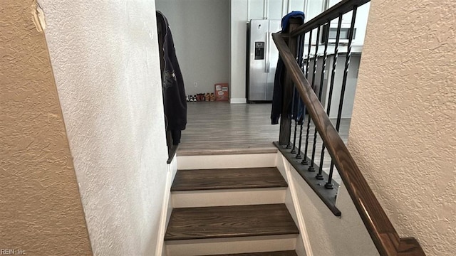 stairs with wood-type flooring