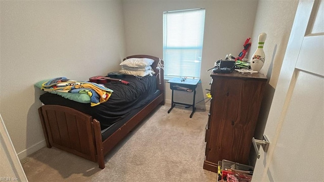 bedroom featuring light carpet