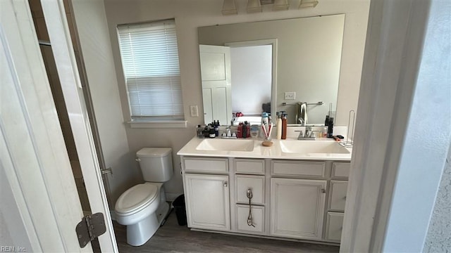 bathroom with vanity, hardwood / wood-style flooring, and toilet