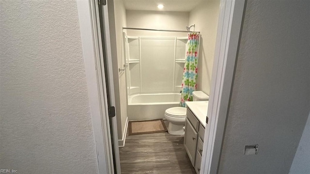 full bathroom featuring vanity, hardwood / wood-style floors, shower / tub combo, and toilet