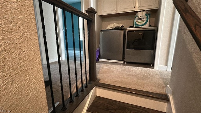 interior space featuring separate washer and dryer and cabinets