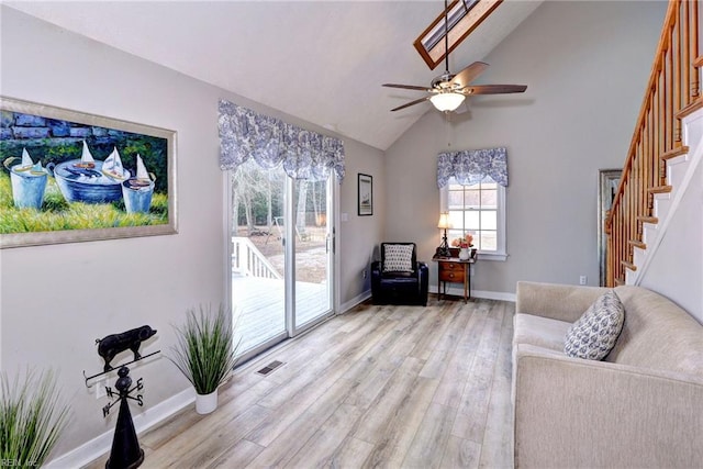 living area featuring ceiling fan, lofted ceiling, and light hardwood / wood-style floors