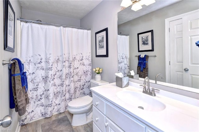 bathroom with vanity, hardwood / wood-style floors, toilet, and walk in shower