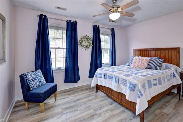 bedroom with ceiling fan and light hardwood / wood-style flooring