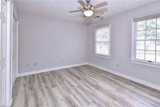 unfurnished room with ceiling fan and light hardwood / wood-style flooring