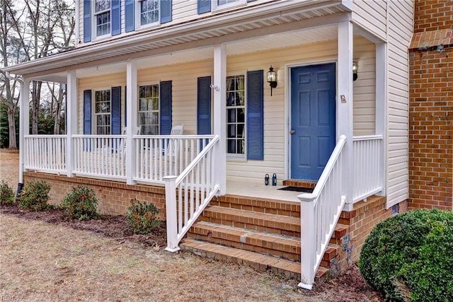 doorway to property featuring covered porch