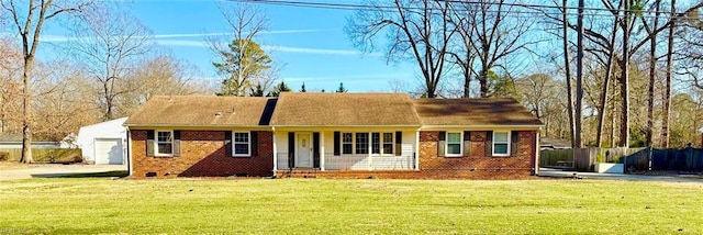 ranch-style house featuring a garage and a front lawn