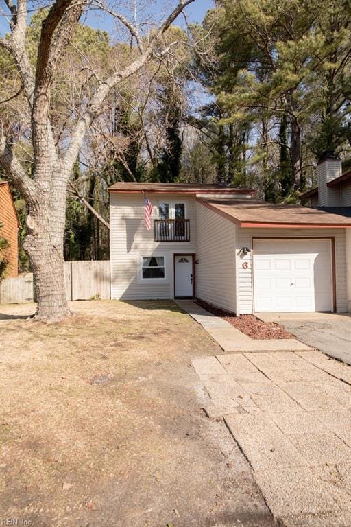 view of front of property with a balcony and a garage