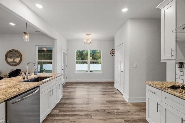 kitchen with white cabinetry, sink, light stone counters, and appliances with stainless steel finishes