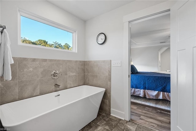 bathroom featuring a bathing tub and tile walls