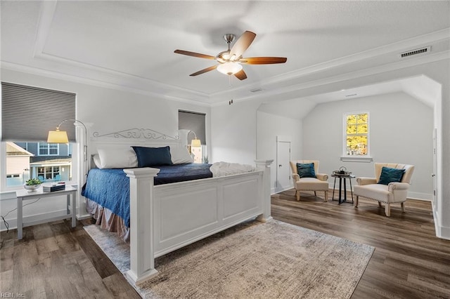 bedroom with crown molding, ceiling fan, dark hardwood / wood-style flooring, and vaulted ceiling