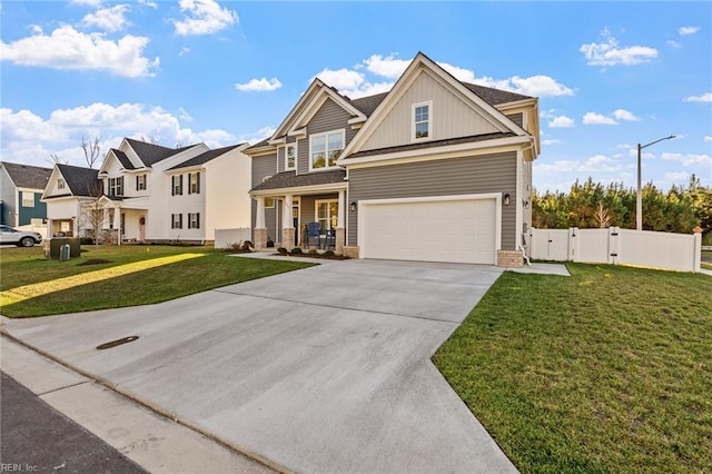 view of front of home featuring a garage, a front yard, and covered porch