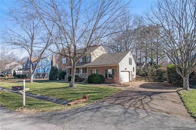 view of front of property with a garage and a front lawn