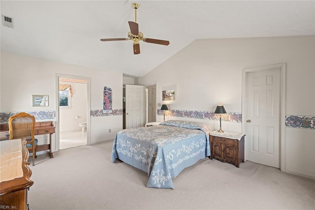 bedroom featuring light carpet, connected bathroom, vaulted ceiling, and ceiling fan