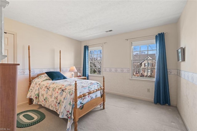 carpeted bedroom featuring a textured ceiling