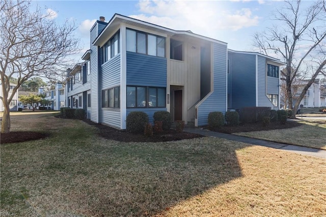 view of side of home featuring a yard