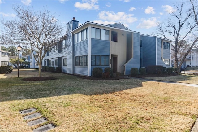 view of side of home with a lawn