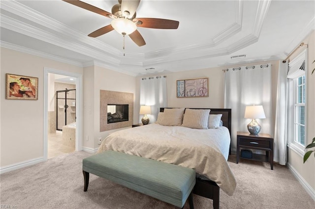 bedroom with a multi sided fireplace, ornamental molding, light colored carpet, ceiling fan, and a raised ceiling