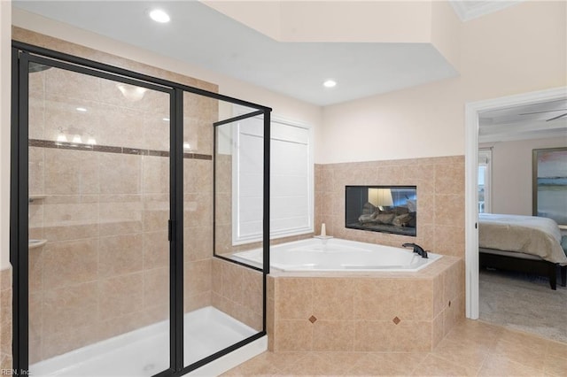 bathroom featuring shower with separate bathtub, tile patterned flooring, and a tile fireplace