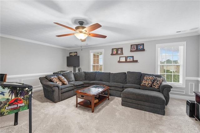 living room featuring crown molding, light colored carpet, and ceiling fan