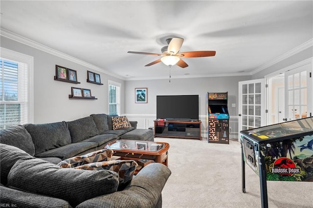 living room featuring ornamental molding, light carpet, ceiling fan, and french doors