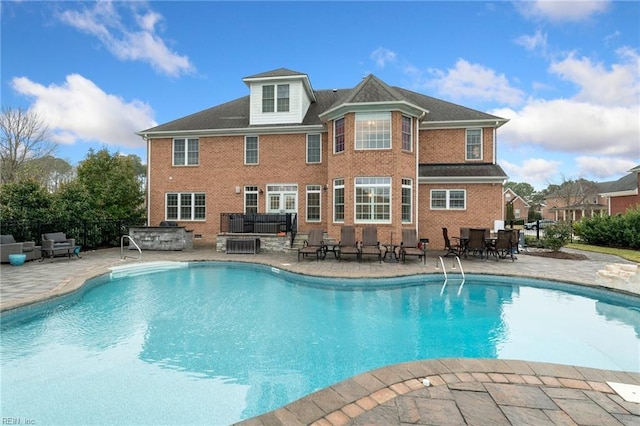 view of swimming pool with a hot tub and a patio area