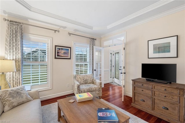 living room featuring dark wood-type flooring, ornamental molding, and french doors