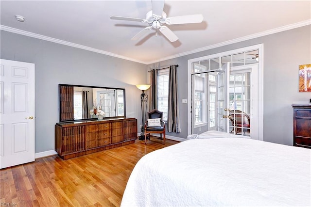 bedroom featuring ornamental molding, access to exterior, and hardwood / wood-style floors