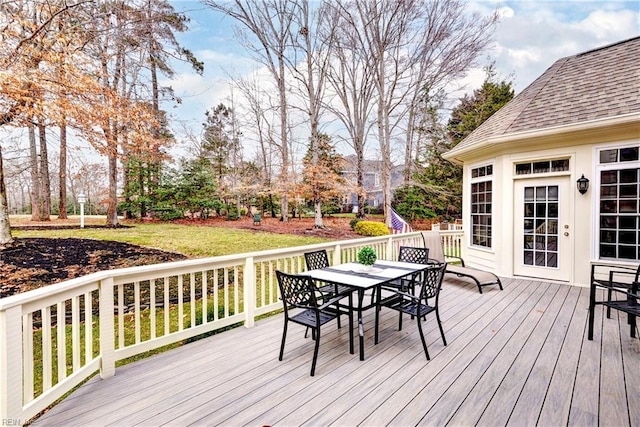 wooden deck featuring a lawn