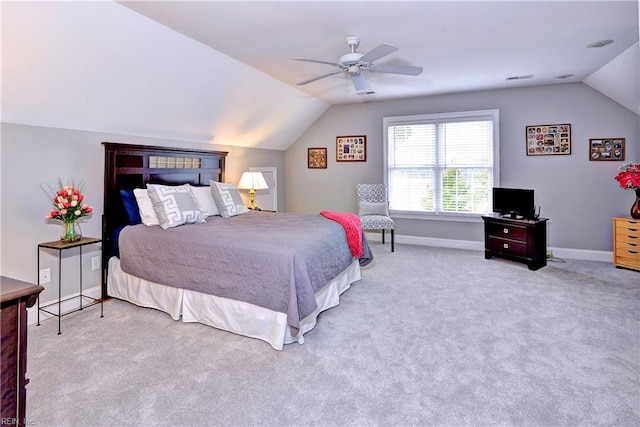 bedroom featuring ceiling fan, light colored carpet, and vaulted ceiling