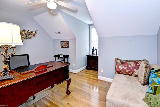 home office with light hardwood / wood-style flooring, ceiling fan, and vaulted ceiling