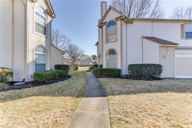 view of side of home featuring a lawn