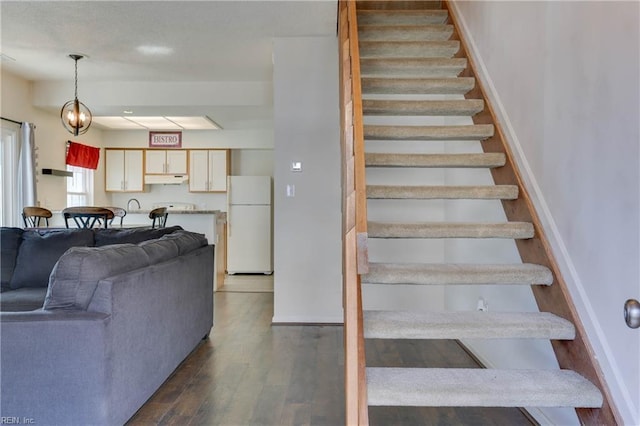 stairs featuring hardwood / wood-style flooring