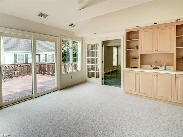 interior space featuring vaulted ceiling and sink