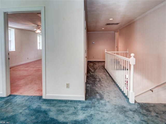 corridor with ornamental molding and carpet flooring