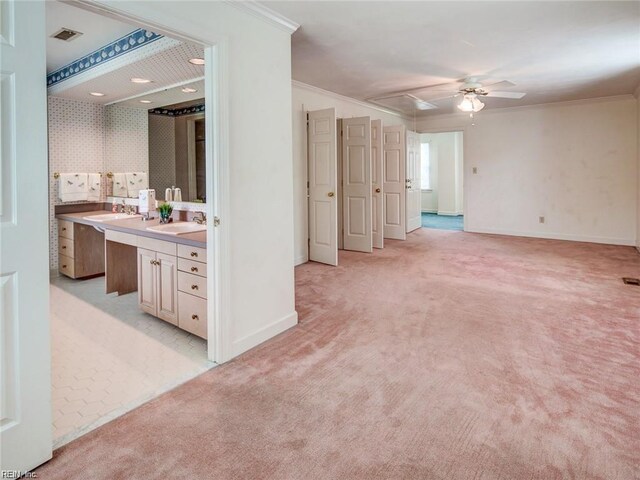 interior space featuring sink, crown molding, and ceiling fan