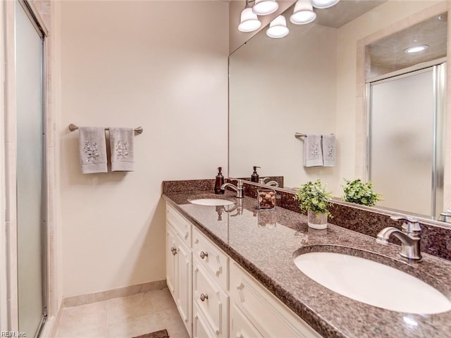 bathroom featuring walk in shower, tile patterned floors, and vanity