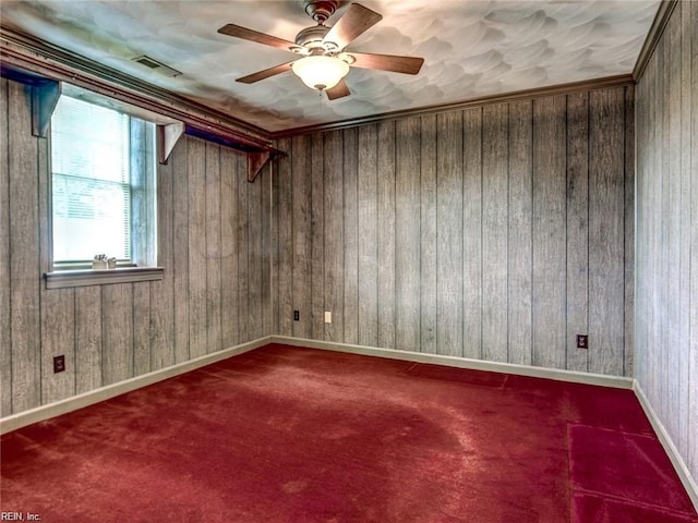 carpeted empty room with crown molding and ceiling fan