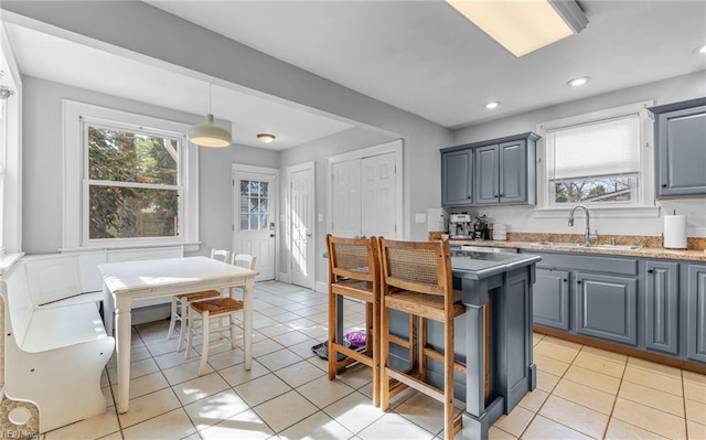 kitchen featuring plenty of natural light, sink, and light tile patterned floors